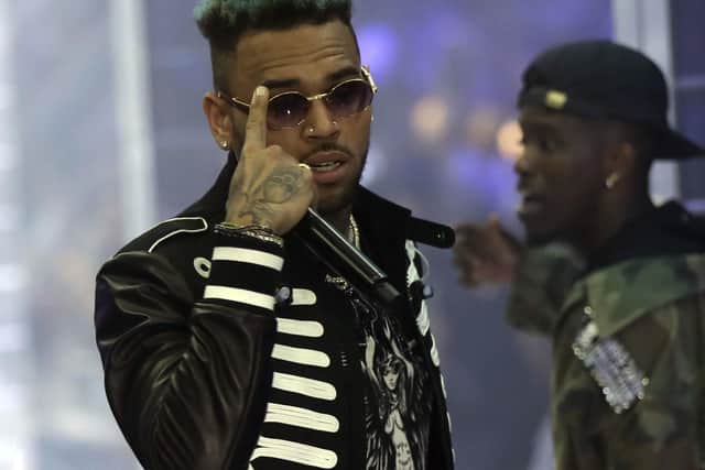 Police officials say U.S. singer Chris Brown and two other people are in custody in Paris after a woman filed a rape complaint. Picture: AP Photo/Luca Bruno, File