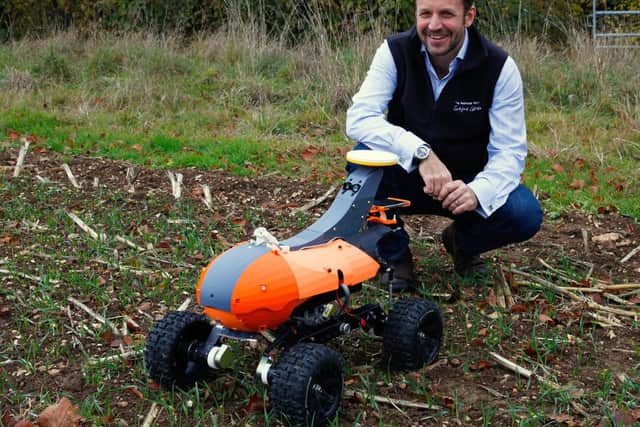 Andrew Hoad, Partner and Head of the Leckford Estate, with Tom monitoring robot prototype
