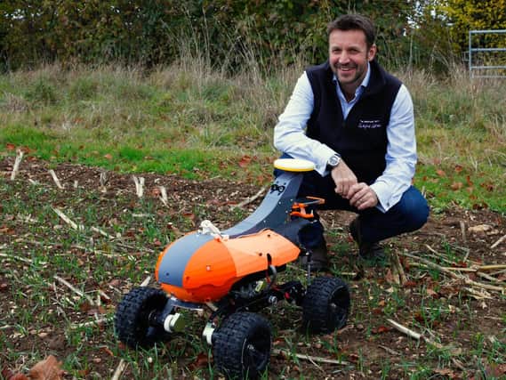 Andrew Hoad, Partner and Head of the Leckford Estate, with Tom monitoring robot prototype