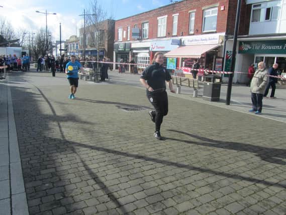 Racers take part in a previous Waterlooville Pancake Race in the town's precinct