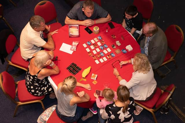 Enjoying a board game at Portsmouth Guildhall's first Games Fest.   Picture: Vernon Nash (180421-011)