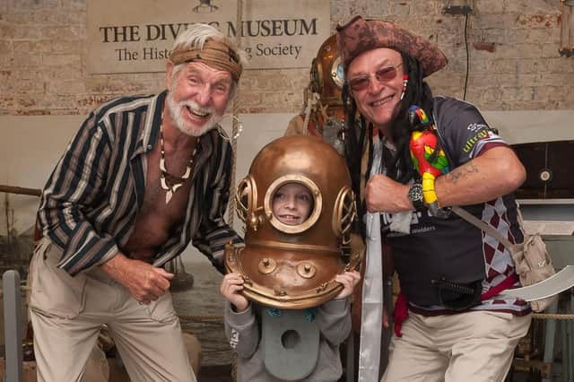 From left, John Dodd, Jack Carraher tries on the divers helmet and James 'Tomo' Thomson. Picture : Keith Woodland (160003-012)