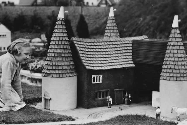 PICTURE 4: Southsea model village and miniature people. The look on the little girls face says it all, delighted at the miniature people around the hop kilns. Photo: Barry Cox collection