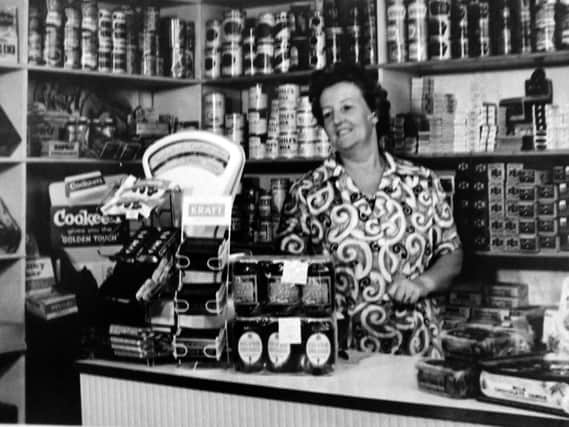 Pictured in her shop at 67, Toronto Road, Landport is Mrs Ethel Morse. Nestles Milk seemed to be popular. Photo: Tony Davis collection.