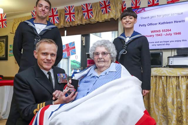 Commanding Officer of HMS Diamond, Commander Ben Keith, presents Kathleen Blower with her Second World War service medal with two of HMS Diamond's ships company.
Picture: LPhot Barry Swainsbury