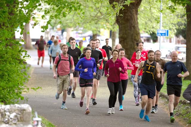 Members of GoodGym Portsmouth running through St Mary's Church, Fratton, on their way to a task