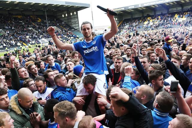 Christian Burgess celebrates Pompey's promotion at Notts County with the Fratton faithful. Picture: Joe Pepler