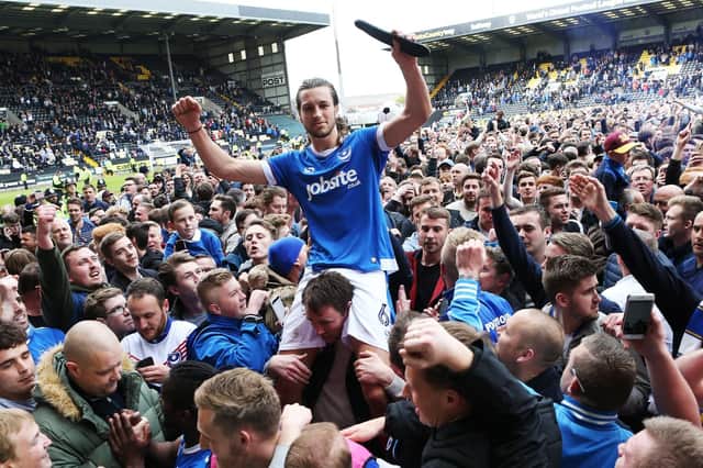 Christian Burgess celebrates Pompey's promotion at Notts County with the Fratton faithful. Picture: Joe Pepler