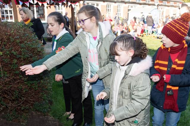 Pupils of Brockhurst School scatter poppy seeds. Picture: Keith Woodland (020219-48)