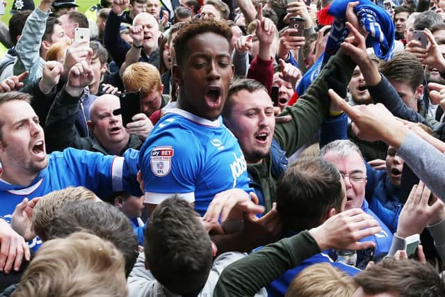 Jamal Lowe celebrates Pompey's promotion at Notts County with the Fratton faithful. Picture: Joe Pepler