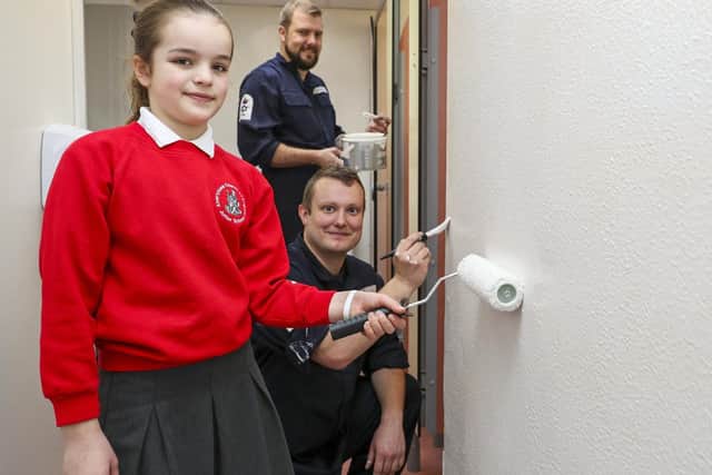 Pictured:  Pupil from Alverstoke Church of England Junior School helping out with the painting in the toilets with Petty Officer Russell Aitken and Able Seaman Specialist Tom Ogden Picture: LPhot Barry Swainsbury