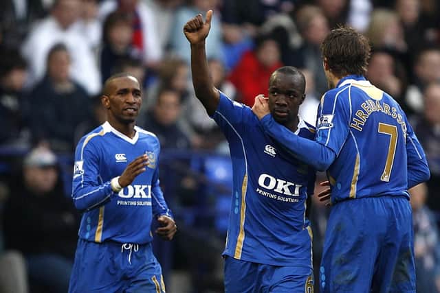 Pompey's Lassana Diarra celebrates scoring with team-mate Hermann Hreidarsson, right