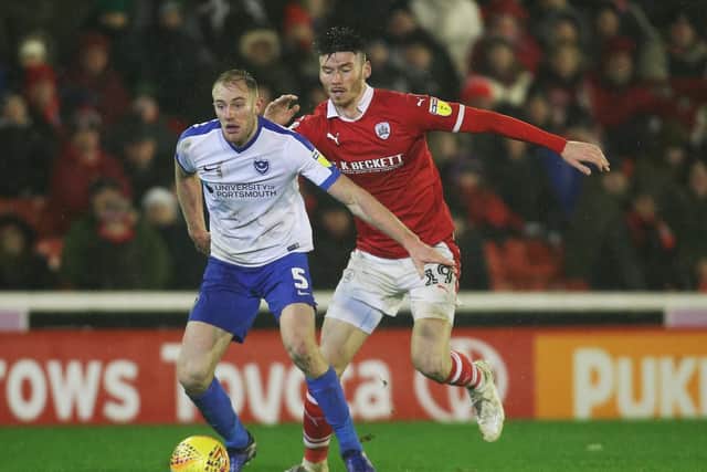 Kieffer Moore attempts to challenge Matt Clarke during Pompey's match at Barnsley in December. Picture: Joe Pepler