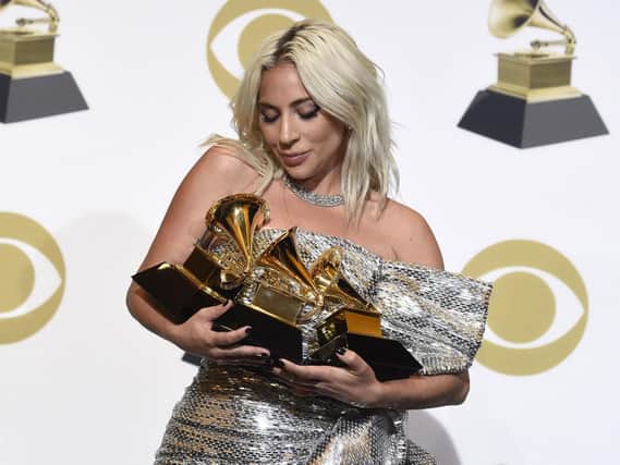 Lady Gaga poses in the press room with her awards at the 61st annual Grammy Awards. Picture: Chris Pizzello/Invision/AP