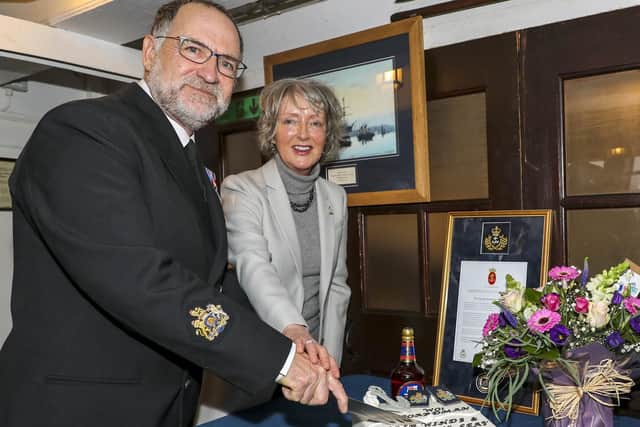 Warrant Officer George Boardman and his wife Dorothy Boardman cutting the cake, after serving 42 years in the Royal Navy.