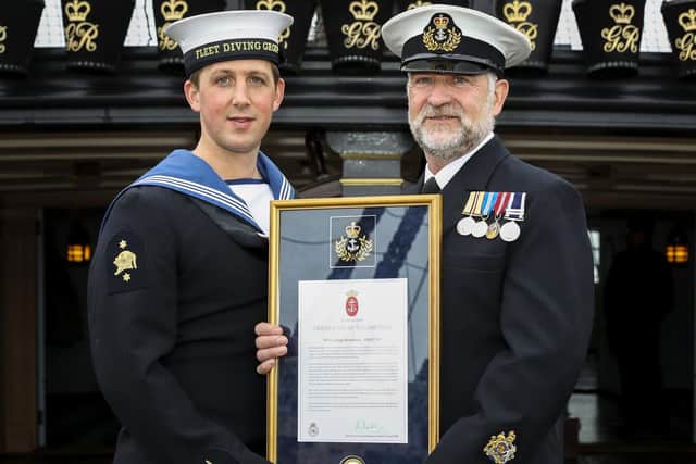 Leading Diver Liam Boardman with his father Warrant Officer George Boardman as he receives his valediction for serving 42 years in the Royal Navy.
