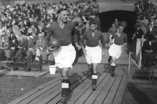 October 19 1936:  Symon, captain of Pompey, leading his team on to the football pitch. PPP-190802-150214003