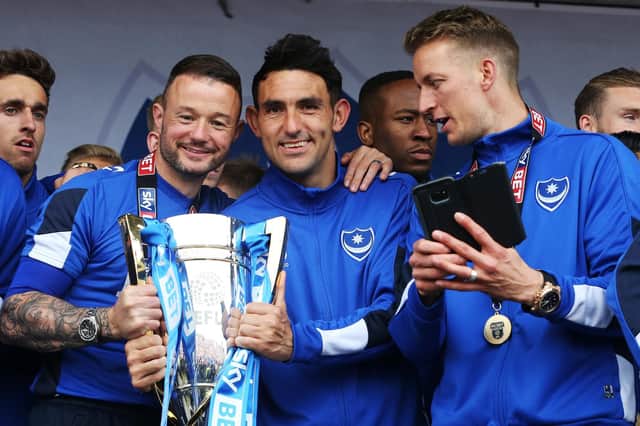 Noel Hunt, left, celebrates Pompey's League Two triumph with Gary Roberts, centre, and Carl Baker. Picture: Joe Pepler