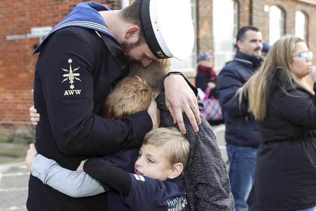A sailor embraces his family after returning to Portsmouth from HMS Diamond. Photo: LPhot Daniel Shepherd