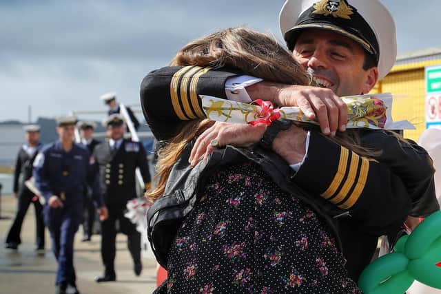 Image of a Royal Navy officer from HMS Sutherland, hugging his daughter after returning from a long deployment at sea. Photo: L(Phot) Barry Wheeler