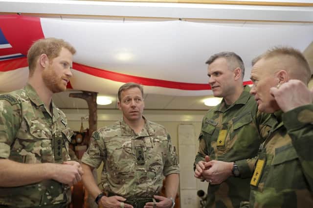 The Duke of Sussex, talking to military personnel during his visit to Commando Helicopter Force at Royal Norwegian Air Force Station Bardufoss.