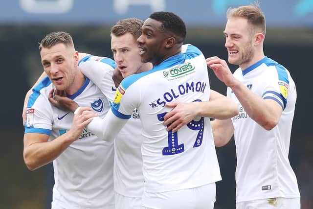 The Pompey players congratulate Bryn Morris, centre, following his eighth-minute opener