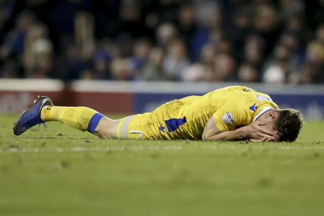 Tom Lockyer lies on the Fratton turf after an alleged punch by James Vaughan. Moments later a bottle appeared to be thrown at the defender. Photo by Robin Jones/Digital South.