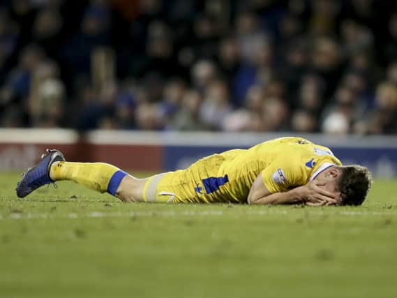 Tom Lockyer lies on the Fratton turf after an alleged punch by James Vaughan. Moments later a bottle appeared to be thrown at the defender. Photo by Robin Jones/Digital South.
