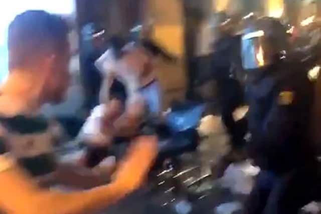 Screengrab taken with permission from a video posted on twitter by @Scotttobin92 of Spanish police officers surrounding Celtic supporters outside St Patrick's Bar in Valencia Picture: Scott Tobin/PA Wire