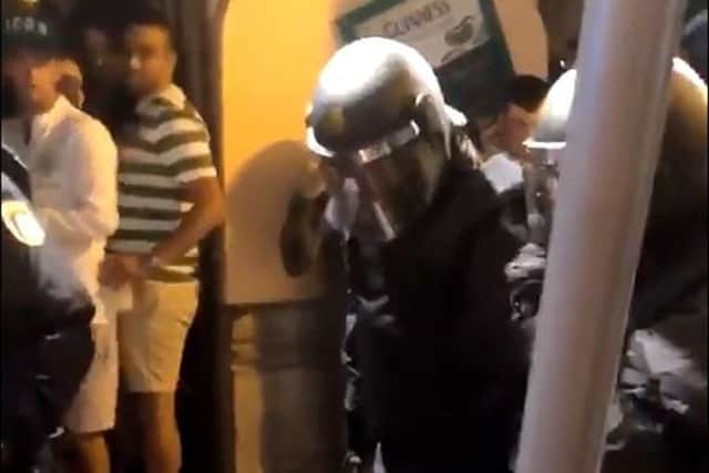 Screengrab taken with permission from a video posted on twitter by @Scotttobin92 of Spanish police officers surrounding Celtic supporters outside St Patrick's Bar in Valencia Picture: Scott Tobin/PA Wire
