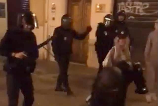 Screengrab taken with permission from a video posted on twitter by @dan_mck98 of a Spanish policeman smashing the headphones of a Celtic supporter. Picture: Daniel McKenna/PA Wire