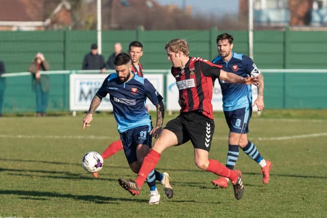 Fareham's Simon Woods competing with AFC Portchester's Marco Gambelardini and Steven Ramsey.  Picture: Vernon Nash (230219-124)