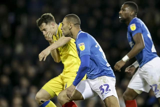 Tom Lockyer falls to ground following a clash with James Vaughan. Picture: Robin Jones/Digital South.