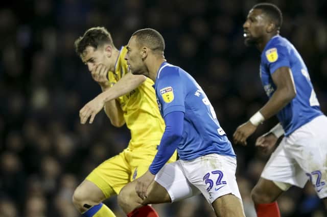 Tom Lockyer falls to ground following a clash with James Vaughan. Picture: Robin Jones/Digital South.