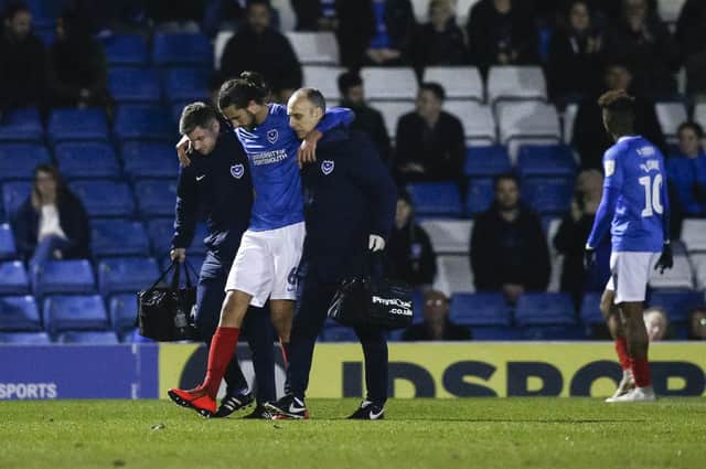 Christian Burgess leaves the pitch in the 88th minute against Bury with an ankle injury. Picture: Daniel Chesterton/phcimages.com