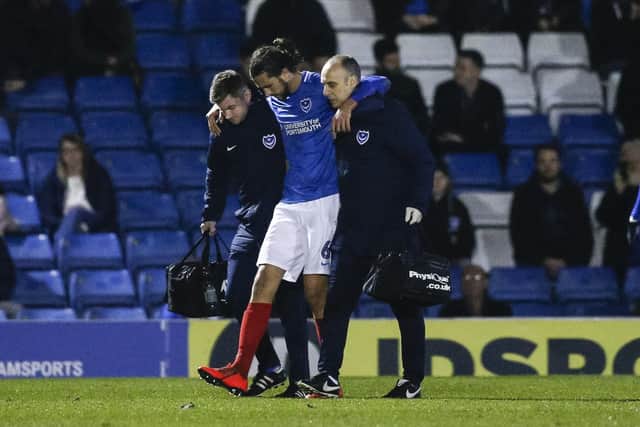 Christian Burgess limps off against Bury. Photo by Daniel Chesterton/phcimages.com