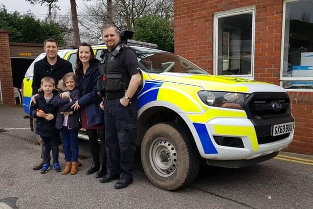 Russell Glass, his children James Glass and Isabella Glass, their stepmother Stacie Davies and PC Mike Harvey at Horsham police station. Picture: Family handout/Sussex Police/PA Wire