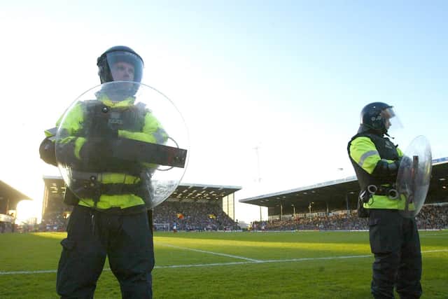 Riot police line the ground during the FA Barclaycard Premiership match between Portsmouth and Southampton at Fratton Park on March 21, 2004 in Portsmouth, England. (Photo by Mike Hewitt/Getty Images)
