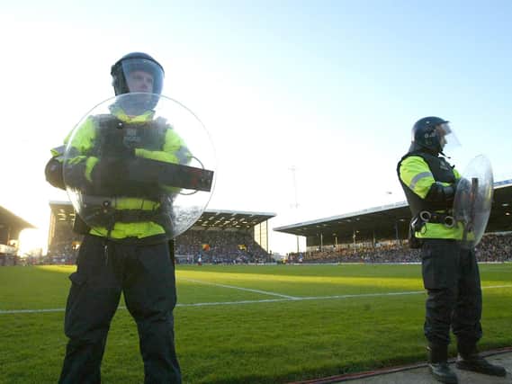 Riot police line the ground during the FA Barclaycard Premiership match between Portsmouth and Southampton at Fratton Park on March 21, 2004 in Portsmouth, England.   (Photo by Mike Hewitt/Getty Images)