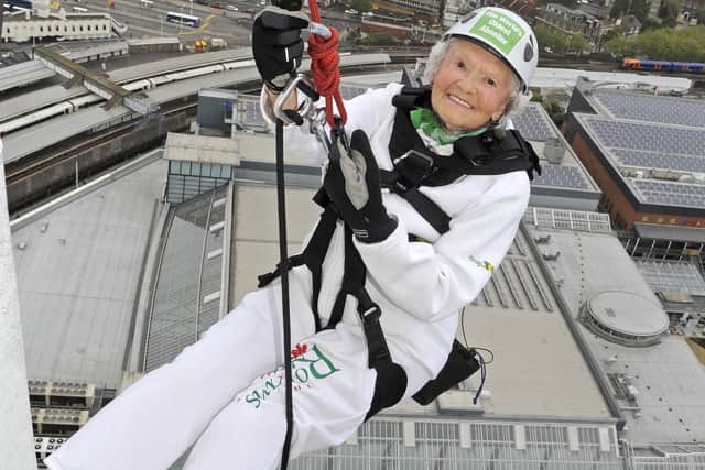 Doris Long prepares to go down the outside of The Spinnaker Tower at Gunwharf Quays. Picture: Malcolm Wells (150712-7022)
