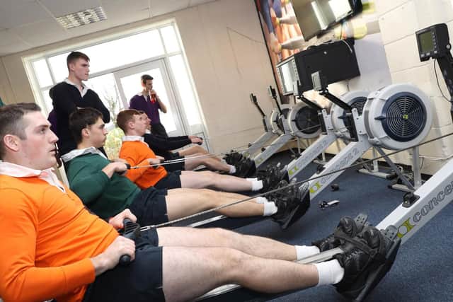 Trainees from HMS Sultan and HMS Collingwood try to row to victory for their team
