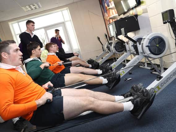 Trainees from HMS Sultan and HMS Collingwood try to row to victory for their team