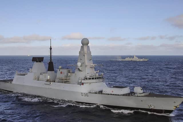 HMS Defender and frigate Admiral Gorshkov in the background as her helicopter lands on deck
Photo: Royal Navy
