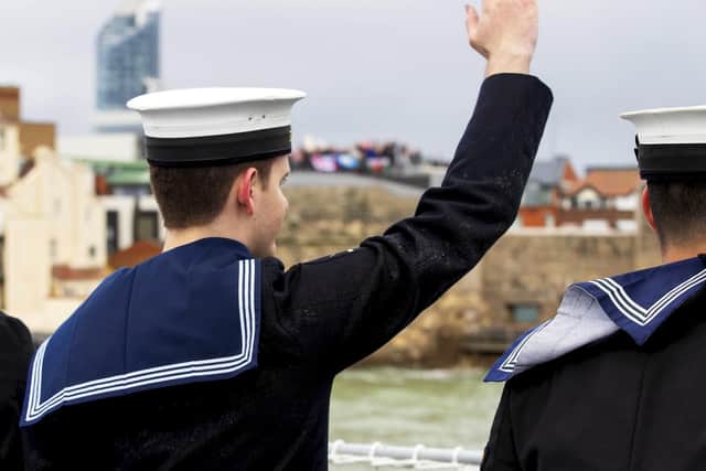 A sailor from HMS Duncan waves goodbye to loved ones at Portsmouth's Round Tower as HMS Duncan sets sail from the city. Photo: LPhot Ben Corbett