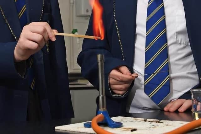 A bunsen burner - the boy is probably wishing he could pick it up and brandish it like a lightsabre