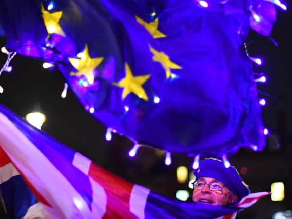 A demonstrator on College Green in Westminster, London after MPs have supported the amended Government motion which rejects a no-deal Brexit at any time and under any circumstances by 321 votes to 278, majority 43. Picture: Victoria Jones/PA Wire