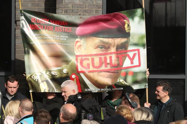 Supporters hold a poster of General Sir Michael David Jackson outside the city hotel  Londonderry, Northern Ireland ahead of the announcement as to whether 17 former British soldiers and two former members of the Official IRA will be prosecuted in connection with the events of Bloody Sunday in the city in January 1972. Picture: Niall Carson/PA Wire