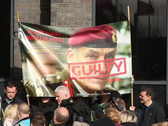 Supporters hold a poster of General Sir Michael David Jackson outside the city hotel  Londonderry, Northern Ireland ahead of the announcement as to whether 17 former British soldiers and two former members of the Official IRA will be prosecuted in connection with the events of Bloody Sunday in the city in January 1972. Picture: Niall Carson/PA Wire
