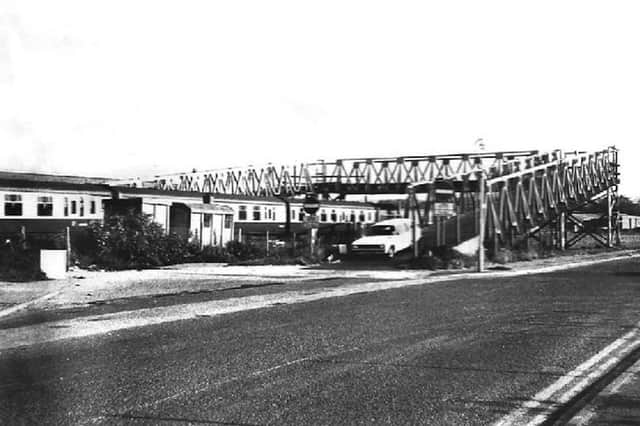 An estate car comes off the Bailey bridge onto the Airport Service Road at Hilsea