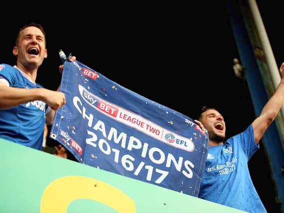 Gareth Evans celebrates claiming the League Two title with skipper Michael Doyle. Now he's seeking more Pompey success. Picture: Harry Murphy/Getty Images